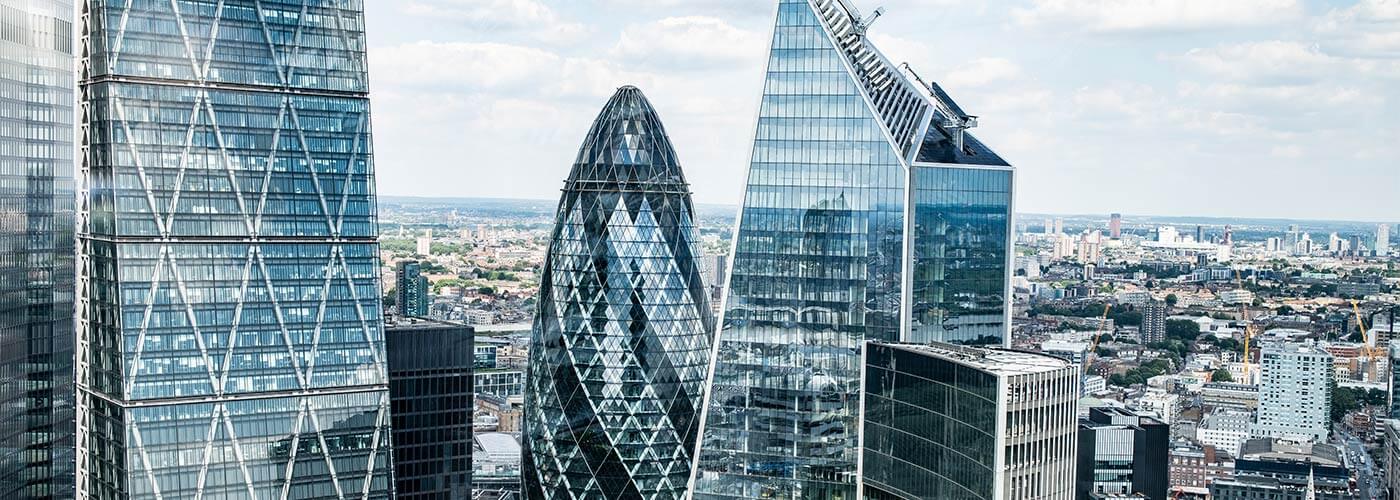 Close up aerial view of the Gherkin in London and surrounding offices.